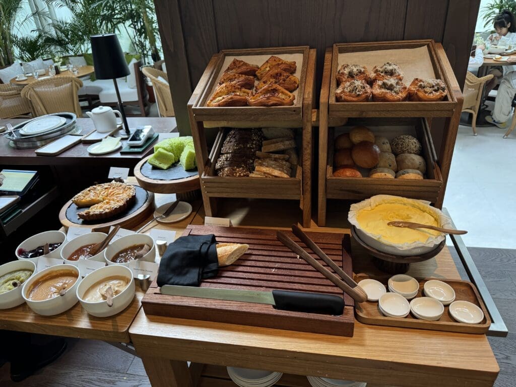 Breakfast buffet with a selection of fresh bread and pastries