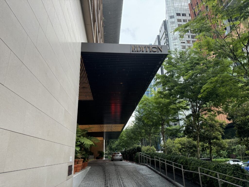 Entrance to The Singapore EDITION with lush greenery and neutral colors